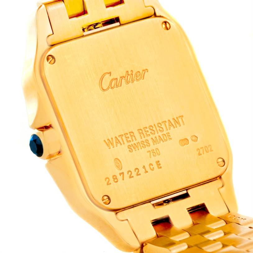 This image shows the back case of a Cartier Santos Demoiselle W25062X9 Women
s Yellow Gold Silver Dial W25062X9 Women
s Yellow Gold Silver Dial watch, highlighting its gold finish and engravings.