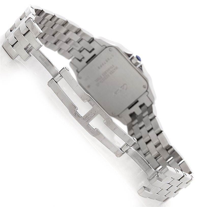 The image shows the back cover and stainless steel bracelet of a Santos Demoiselle model by Cartier at an angle.