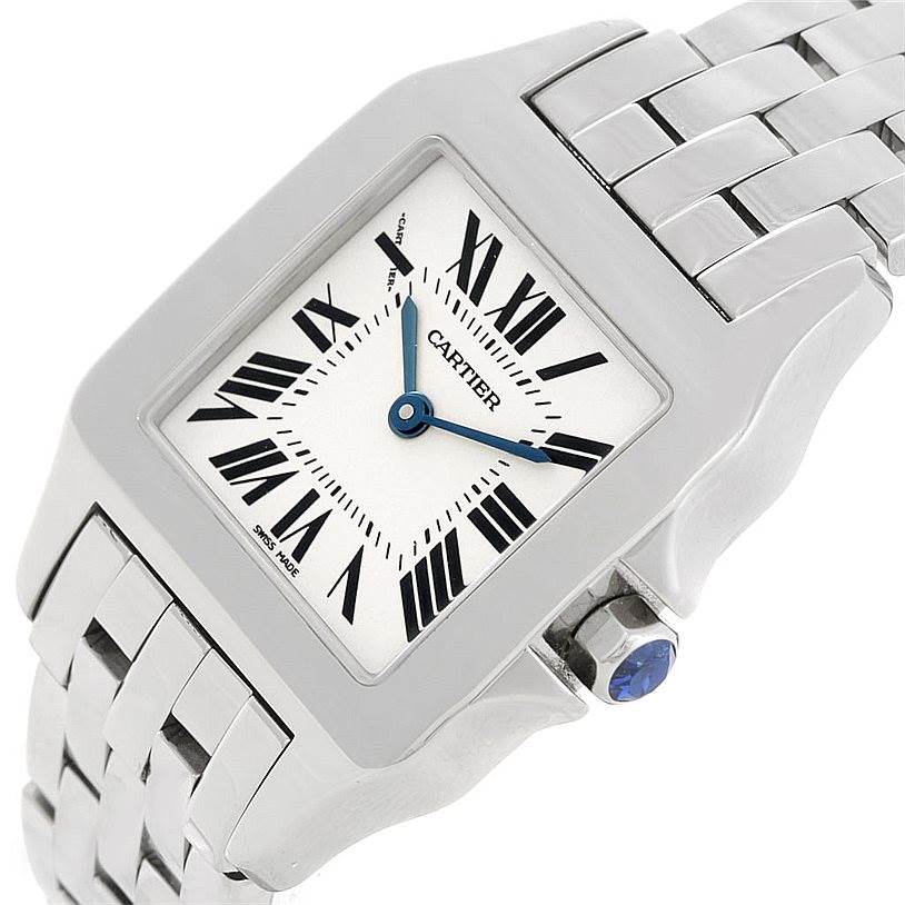 The image shows a close-up of a Cartier Santos Demoiselle W25065Z5 Women
s Stainless Steel Silver Dial W25065Z5 Women
s Stainless Steel Silver Dial watch from an angled top view, showcasing the face, crown, and part of the bracelet.