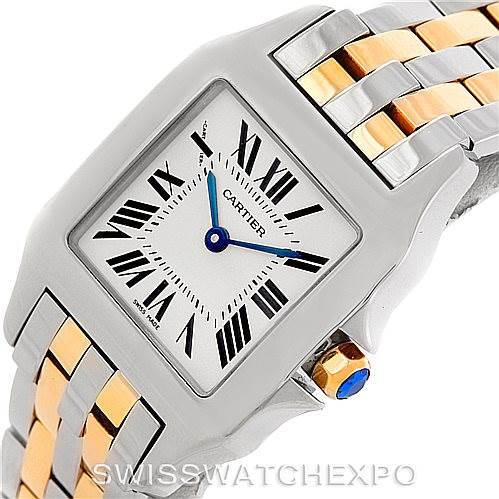The Cartier Santos Demoiselle W25067Z6 Women's Steel and Gold (two tone) Silver Dial W25067Z6 Women's Steel and Gold (two tone) Silver Dial watch is shown at a slight angle, displaying its face, bezel, and part of its two-tone bracelet.