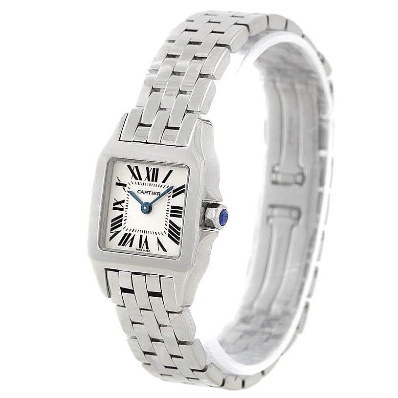 The image shows a Cartier Santos Demoiselle W25064Z5 Women's Stainless Steel Silver Dial W25064Z5 Women's Stainless Steel Silver Dial watch viewed from an oblique angle, highlighting its face, bezel, and part of the bracelet.