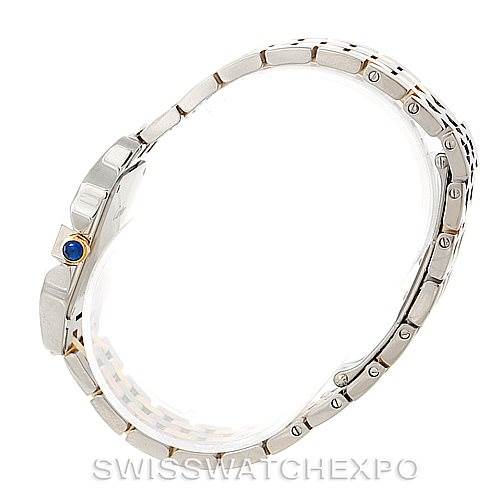 This image shows a side profile view of the Santos Demoiselle watch by Cartier, highlighting the bracelet, side of the case, and crown with a blue gem.