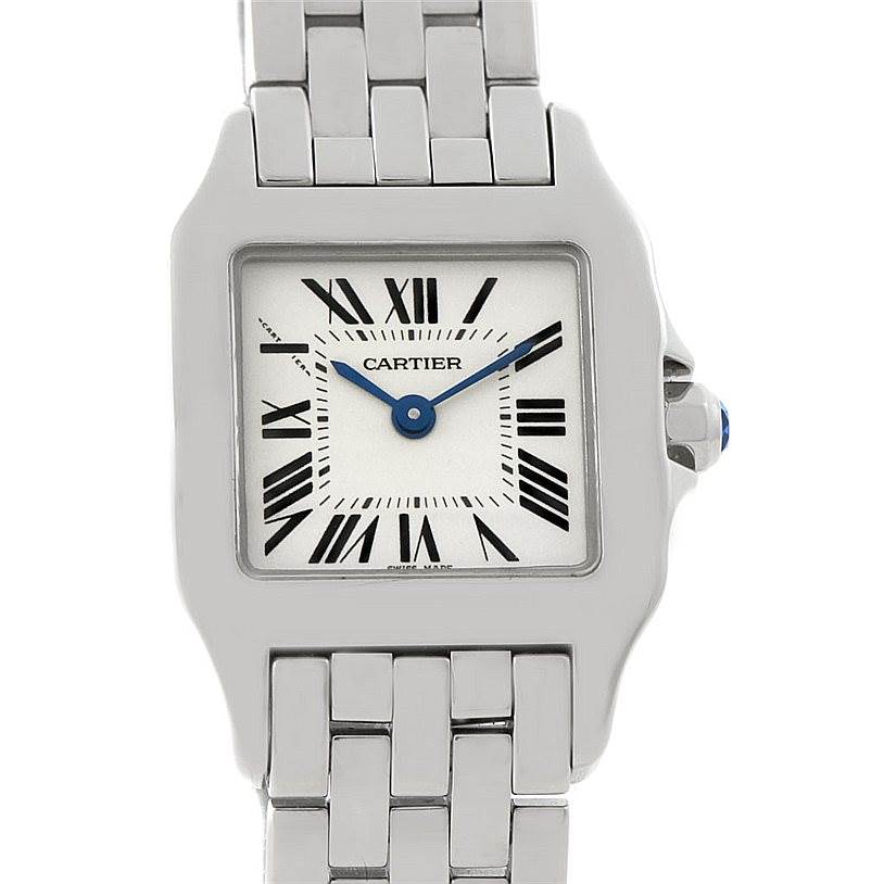 The image shows a close-up of the face and a portion of the bracelet of a Cartier Santos Demoiselle W25064Z5 Women's Stainless Steel Silver Dial W25064Z5 Women's Stainless Steel Silver Dial watch.