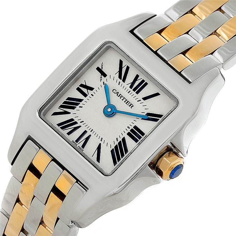This Cartier Santos Demoiselle W25066Z6 Women's Steel and Gold (two tone) Silver Dial W25066Z6 Women's Steel and Gold (two tone) Silver Dial watch is shown from a slight angle, highlighting its face, bracelet, and crown.