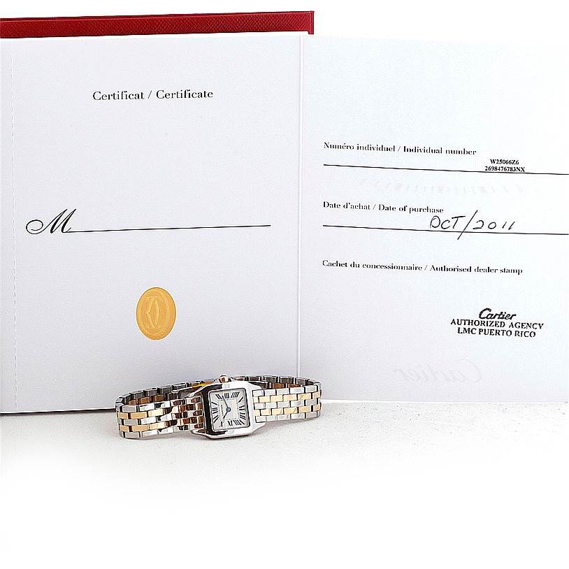 The image shows a Cartier Santos Demoiselle W25066Z6 Women's Steel and Gold (two tone) Silver Dial W25066Z6 Women's Steel and Gold (two tone) Silver Dial watch placed in front of its certificate of authenticity and purchase documents.