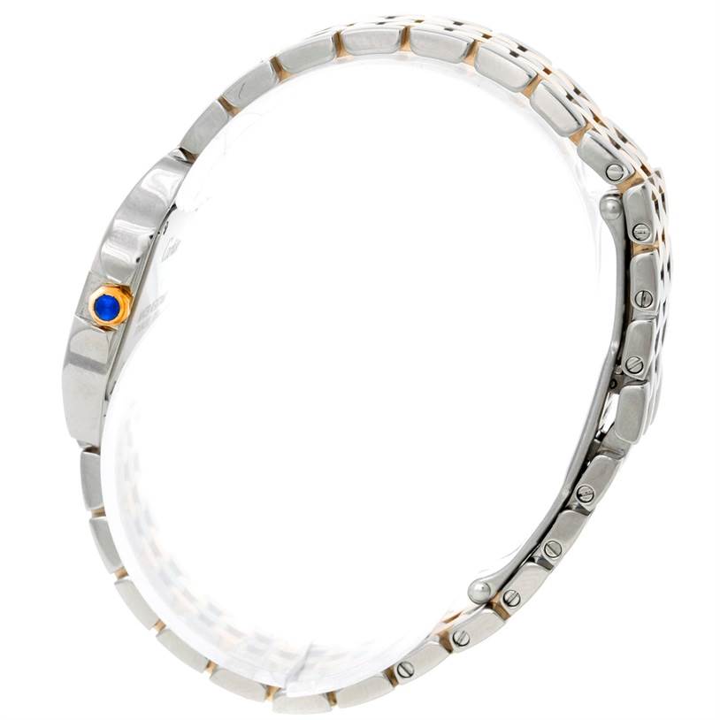 The image shows a side view of the Santos Demoiselle watch by Cartier, highlighting the bracelet and crown with a blue stone.