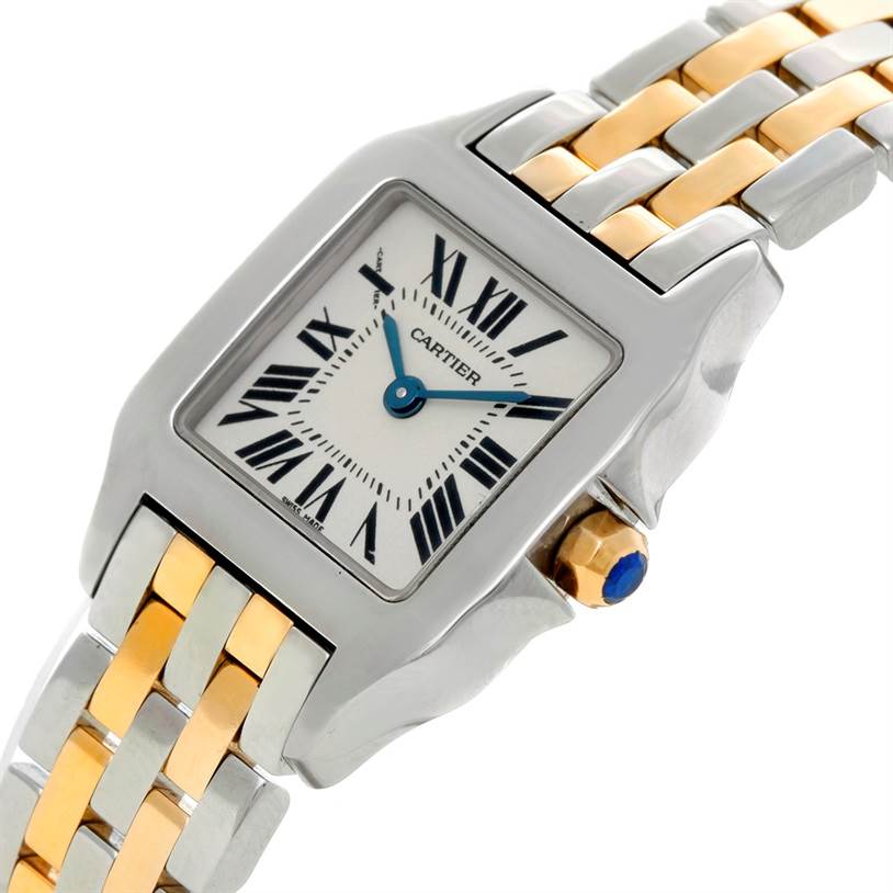 The image shows a close-up angled view of the Cartier Santos Demoiselle W25066Z6 Women's Steel and Gold (two tone) Silver Dial W25066Z6 Women's Steel and Gold (two tone) Silver Dial watch, highlighting its face, bezel, crown, and part of its bracelet.