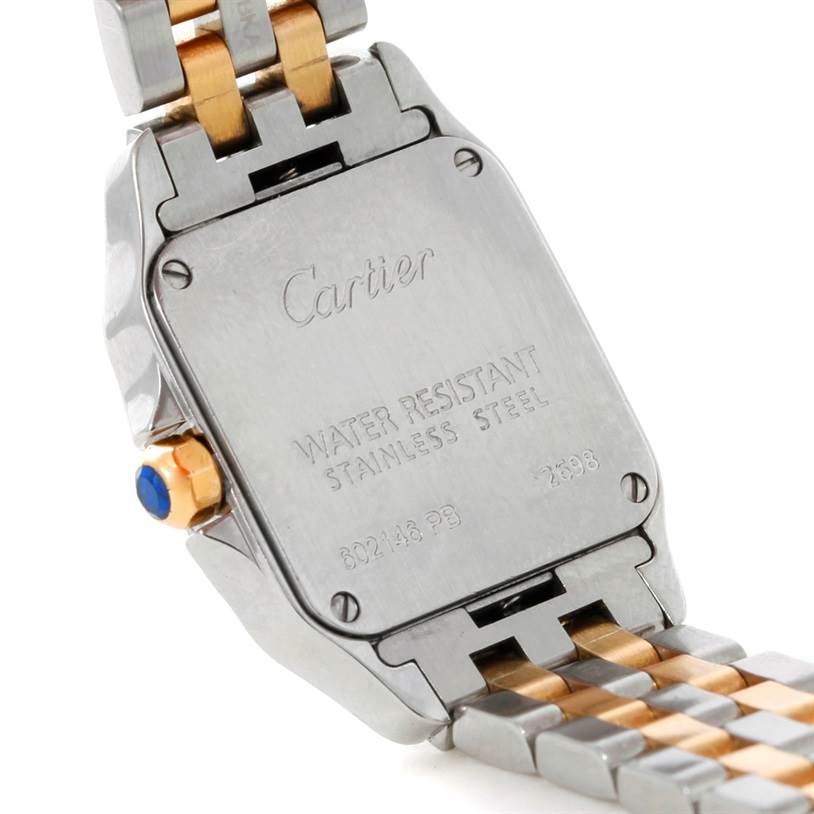 The image shows the back case and part of the bracelet of the Cartier Santos Demoiselle W25066Z6 Women's Steel and Gold (two tone) Silver Dial W25066Z6 Women's Steel and Gold (two tone) Silver Dial watch, highlighting its water resistance and stainless steel features.