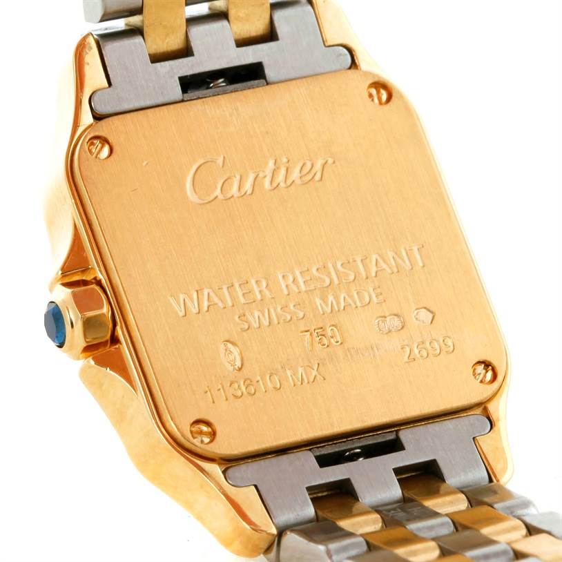 The image shows the backside of a Cartier Santos Demoiselle W25063Z6 Women's Yellow Gold Silver Dial W25063Z6 Women's Yellow Gold Silver Dial watch, highlighting its backplate and part of the metal bracelet.