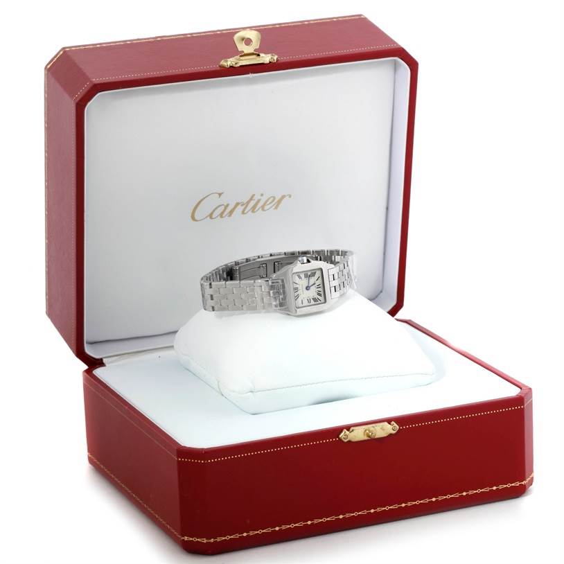 The Cartier Santos Demoiselle W25064Z5 Women's Stainless Steel Silver Dial W25064Z5 Women's Stainless Steel Silver Dial watch is shown in a red Cartier box, placed at a slight angle with the face and bracelet visible.