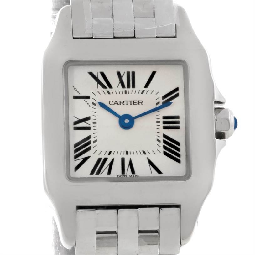 This image shows a close-up, front-on view of the Cartier Santos Demoiselle W25064Z5 Women's Stainless Steel Silver Dial W25064Z5 Women's Stainless Steel Silver Dial watch face and part of its bracelet.