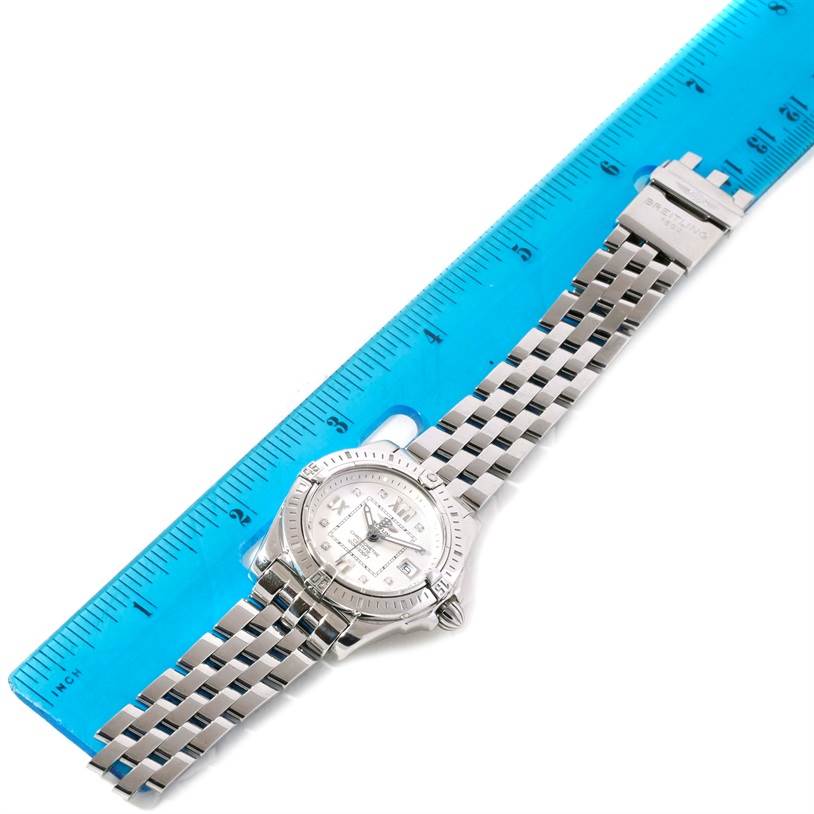 The Breitling A71356 Women's Stainless Steel Silver Dial A71356 Women's Stainless Steel Silver Dial Windrider Cockpit Silver Diamond Dial Ladies Watch A71356 is shown from above, alongside a blue ruler for scale.