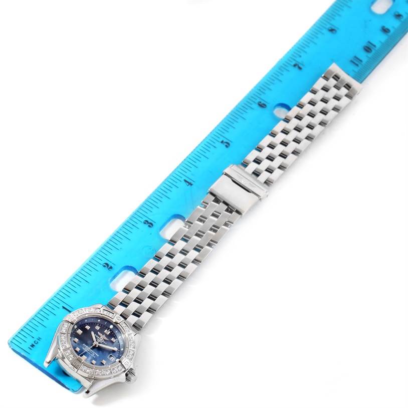 The Breitling A72345 Women's Stainless Steel Mother of Pearl Dial A72345 Women's Stainless Steel Mother of Pearl Dial Callisto Ladies Blue Mother of Pearl Diamond Watch A72345 is pictured lying flat with a ruler, showing its face and metal band.