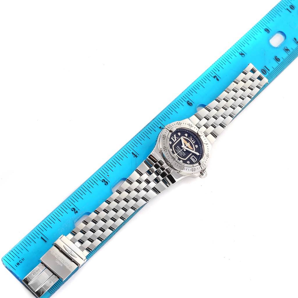 The Breitling A71340 Women's Stainless Steel Black Dial A71340 Women's Stainless Steel Black Dial Starliner A71340 is shown flat with a steel bracelet and black diamond dial, measured against a blue ruler.