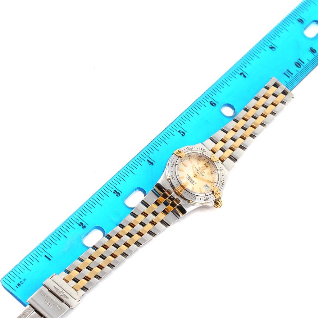 The Breitling B71340 Women's Steel and Gold (two tone) Mother of Pearl Dial B71340 Women's Steel and Gold (two tone) Mother of Pearl Dial Starliner Steel 18K Yellow Gold MOP Dial Ladies Watch B71340 is shown from the top view with a ruler for scale.