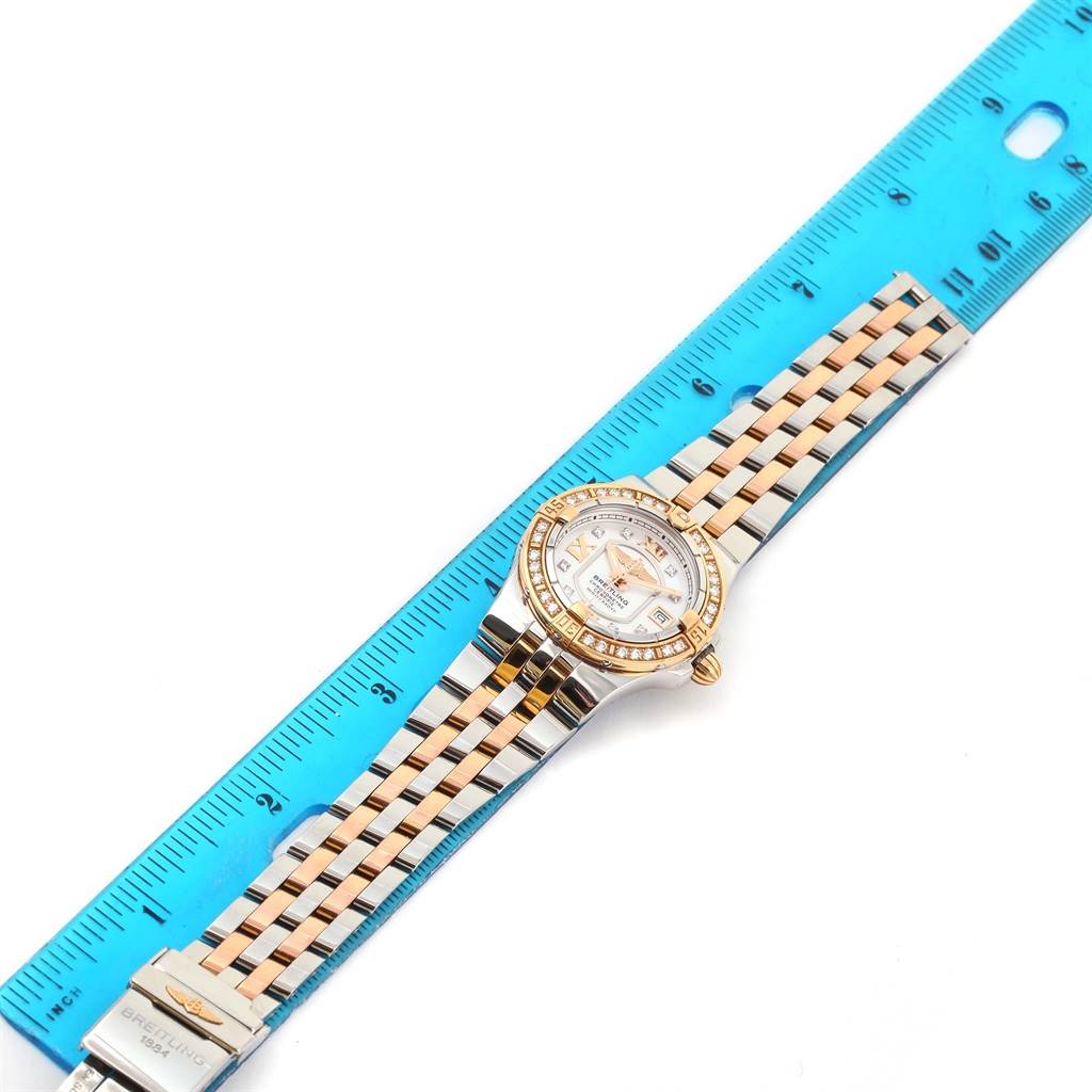 The Breitling C71340 Women's Steel and Gold (two tone) Mother of Pearl Dial C71340 Women's Steel and Gold (two tone) Mother of Pearl Dial Galactic 30 Ladies Steel 18K Rose Gold Diamond Watch C71340 is shown laid flat next to a ruler, highlighting the band and face.
