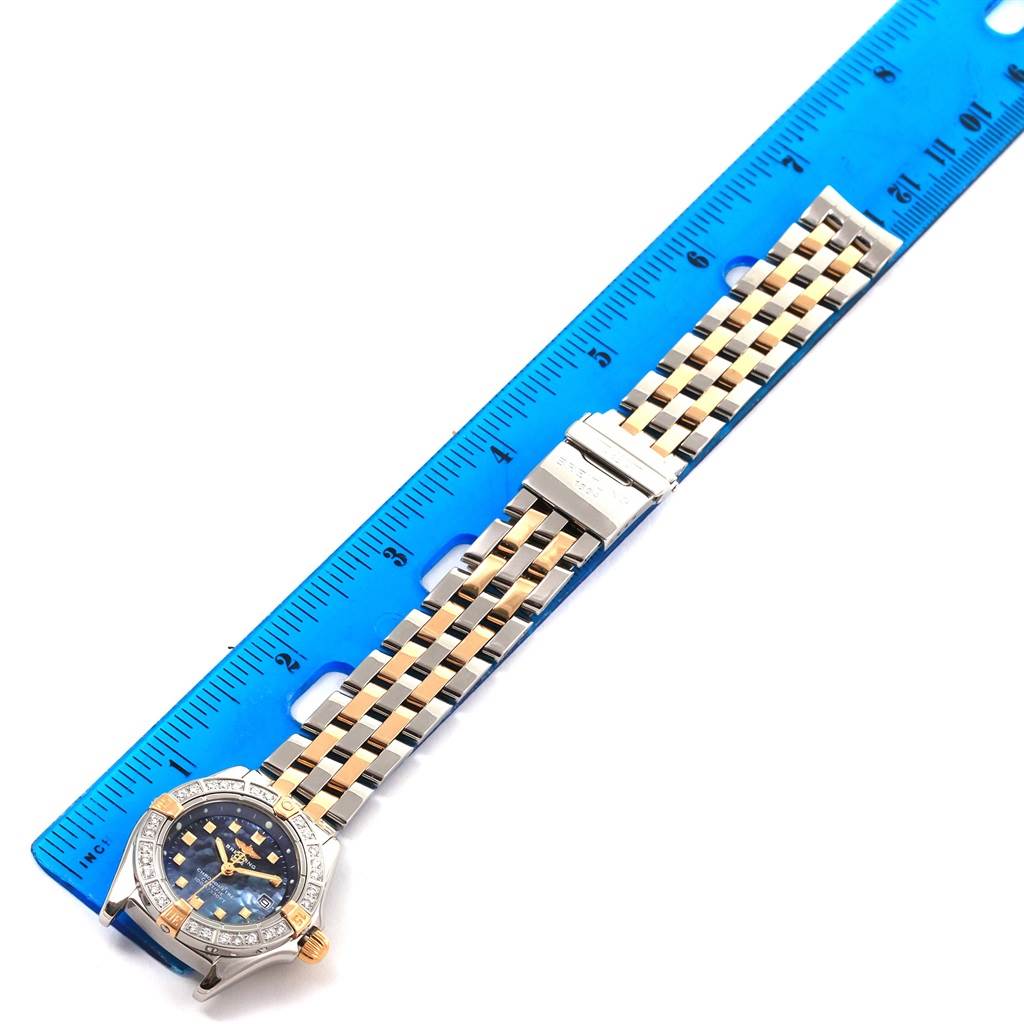 The image shows a top view of the Callisto Ladies Blue Mother of Pearl Diamond Watch B72345 by Breitling B72345 Women's Stainless Steel Mother of Pearl Dial B72345 Women's Stainless Steel Mother of Pearl Dial, alongside a blue ruler.