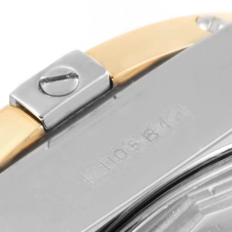 This close-up image of the Breitling D71356 Women's Stainless Steel Mother of Pearl Dial D71356 Women's Stainless Steel Mother of Pearl Dial Cockpit Ladies Steel 18K Yellow Gold Diamond Watch D71356 shows a side angle of the case and bracelet link.