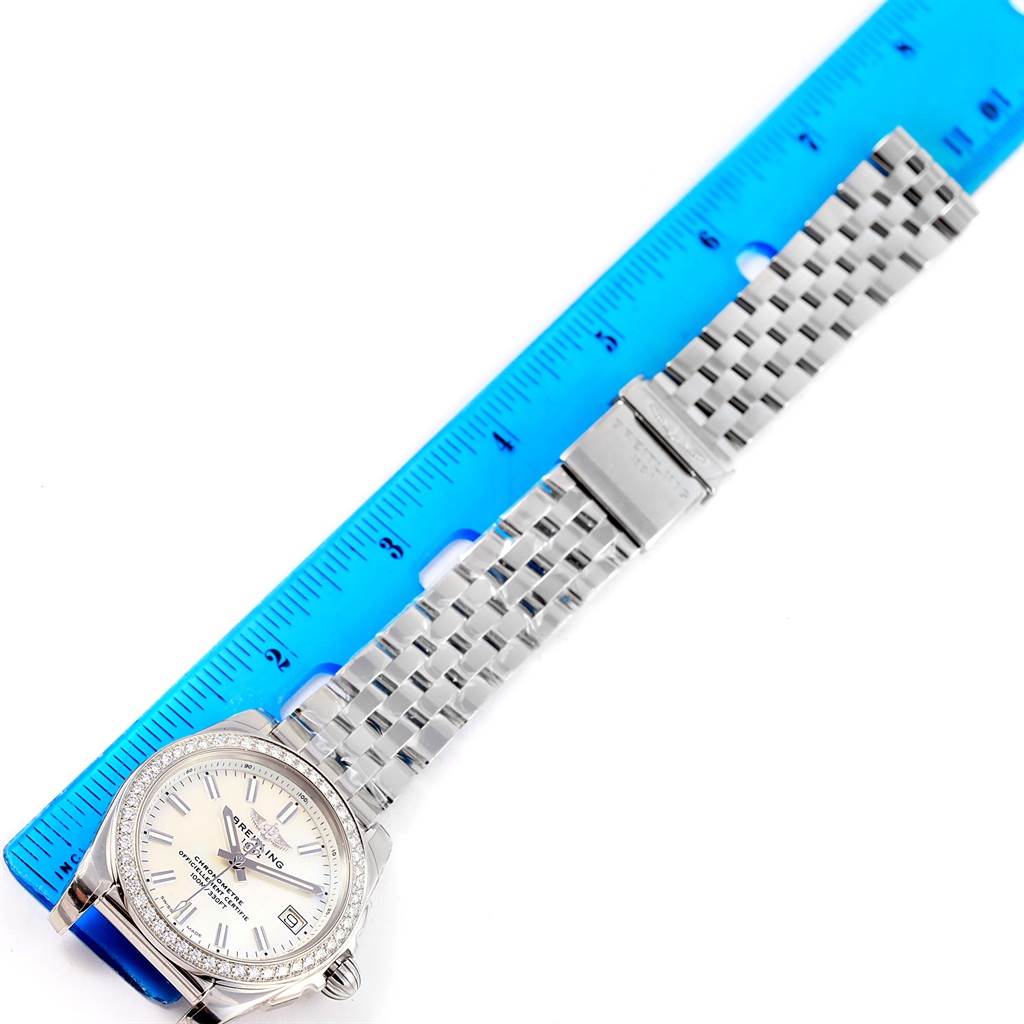 The image shows the Breitling A7433053/A779/376A Women's Stainless Steel Mother of Pearl Dial A7433053/A779/376A Women's Stainless Steel Mother of Pearl Dial Galactic 36 MOP Dial Diamond Ladies Watch W74330 laid flat with a blue ruler for scale.