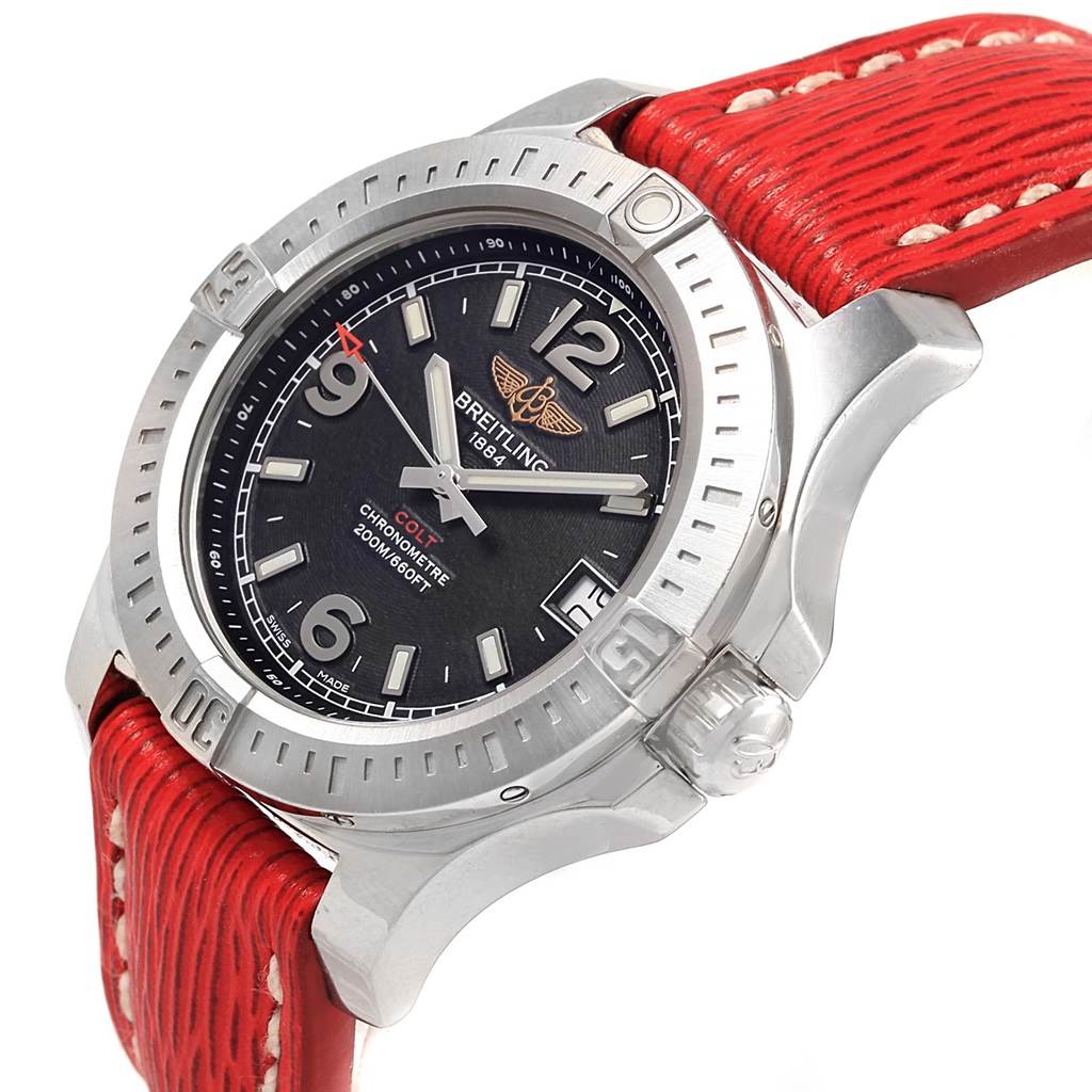 The image shows a Colt 36 Quartz Steel Men's Watch A74389 by Breitling A74389 Women's Stainless Steel Black Dial A74389 Women's Stainless Steel Black Dial at a slight angle, highlighting the face, bezel, and red strap.