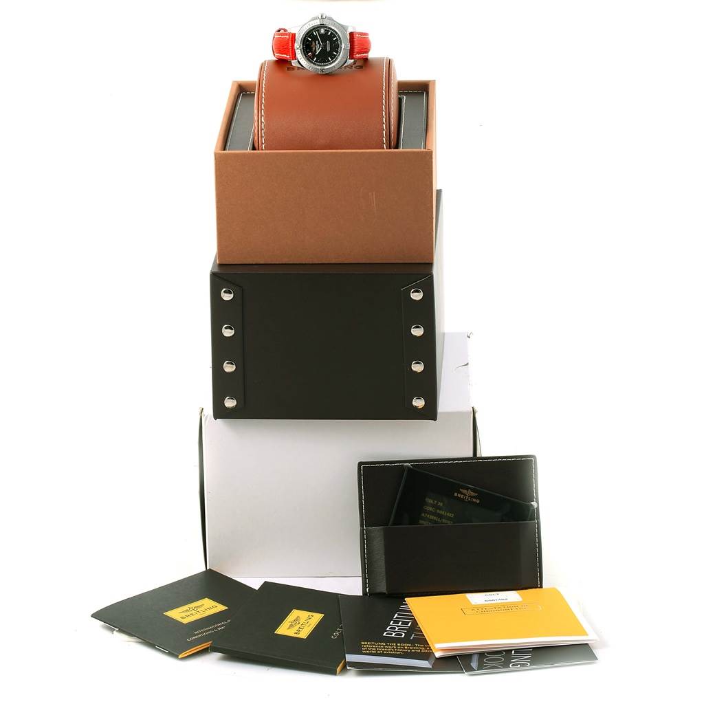 The image shows the Breitling A74389 Women's Stainless Steel Black Dial A74389 Women's Stainless Steel Black Dial Colt 36 Quartz Steel Mens Watch A74389 atop its box and papers at a slightly angled and elevated view.