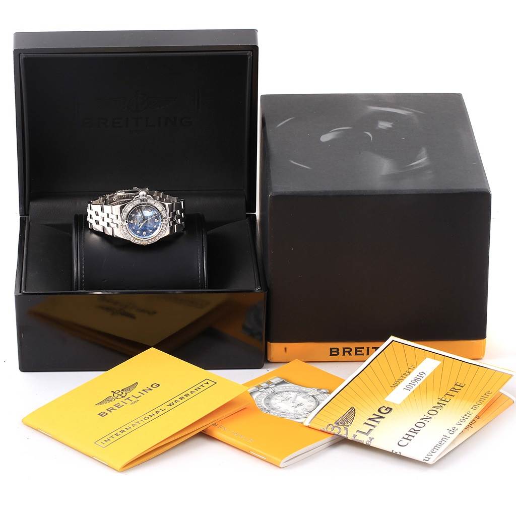 The image shows the Breitling A71340 Women
s Stainless Steel Mother of Pearl Dial A71340 Women
s Stainless Steel Mother of Pearl Dial Starliner Blue Mother of Pearl Diamond Watch A71340 with its original box, papers, and accessories.