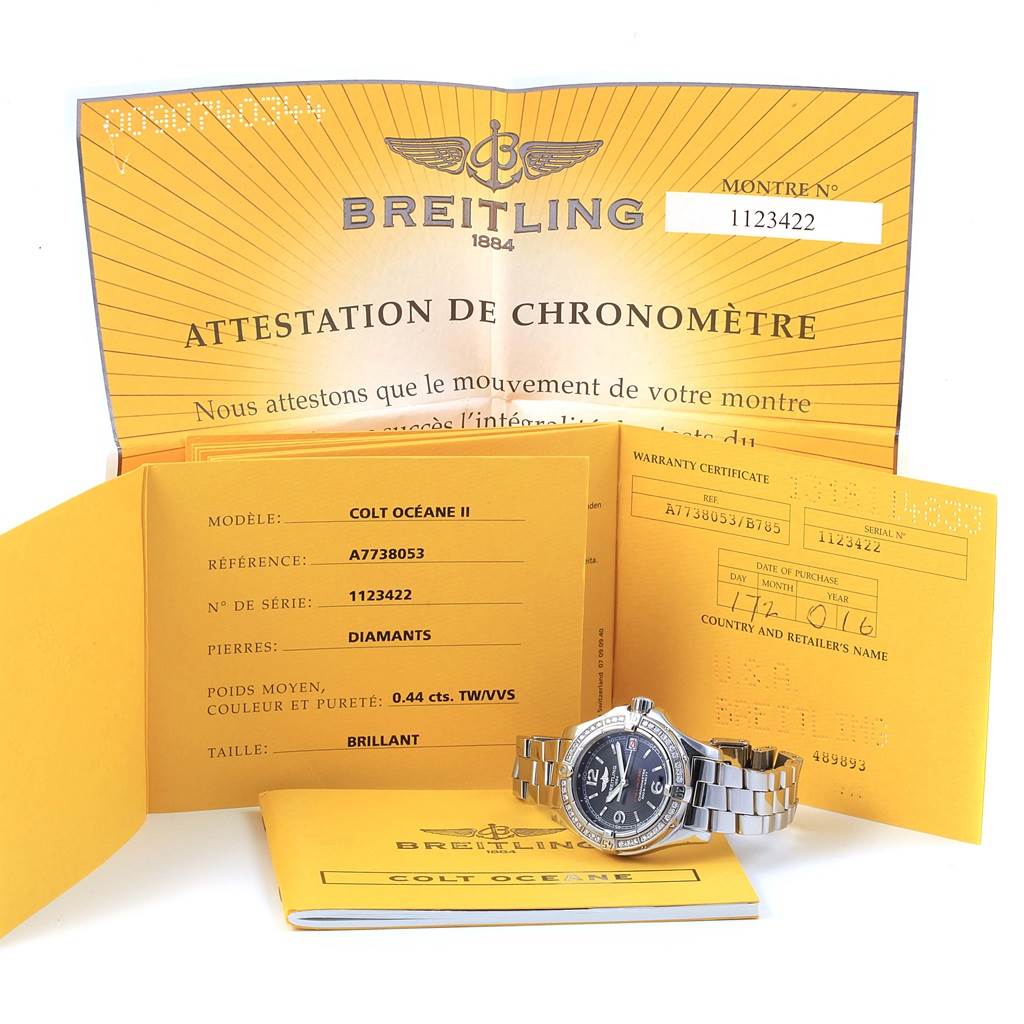 The photo shows a Breitling A77380 Women's Stainless Steel Black Dial A77380 Women's Stainless Steel Black Dial Colt Oceane A77380 watch with documents, including certification and warranty.