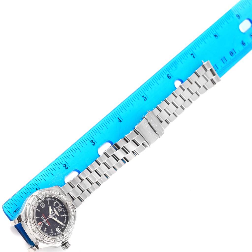 The image shows a Breitling A77380 Women's Stainless Steel Black Dial A77380 Women's Stainless Steel Black Dial Colt Oceane Stainless Steel Diamond Ladies Watch A77380 with its band extended, measured against a blue ruler.