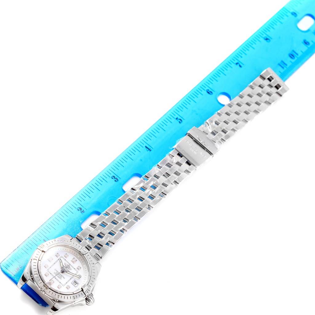 The image shows a Breitling A71356 Women's Stainless Steel Mother of Pearl Dial A71356 Women's Stainless Steel Mother of Pearl Dial Cockpit Mother of Pearl Diamond Steel Ladies Watch A71356 model laid flat next to a blue ruler measuring its length.