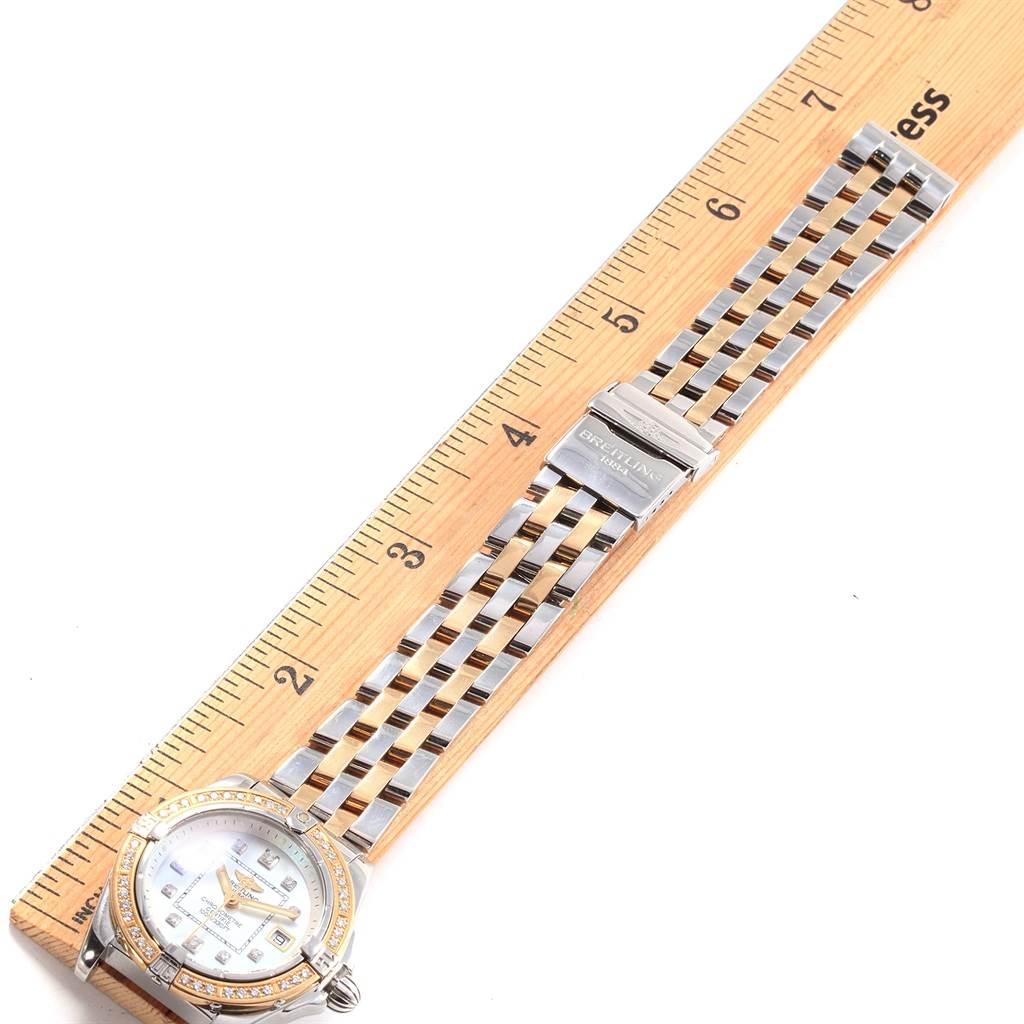 The Breitling D71356 Women's Stainless Steel Mother of Pearl Dial D71356 Women's Stainless Steel Mother of Pearl Dial Cockpit Ladies Steel 18K Yellow Gold Diamond Watch D71356 is shown from a top-down angle, displaying the face and bracelet.