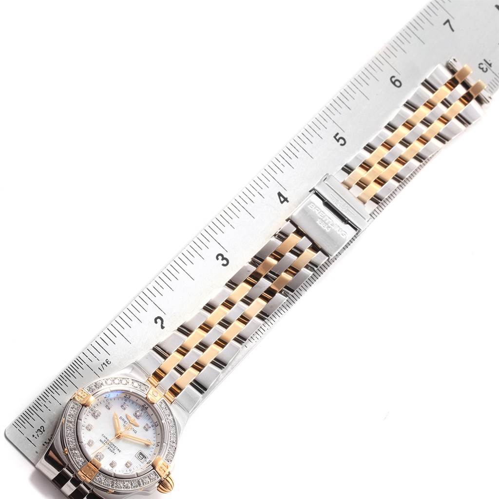 The Breitling B71340 Women's Steel and Gold (two tone) Mother of Pearl Dial B71340 Women's Steel and Gold (two tone) Mother of Pearl Dial Starliner B71340 watch is shown from a top-down angle, including its dial, bracelet, and a portion of the clasp.