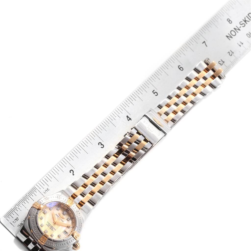 The image shows the Breitling B71340 Women's Steel and Gold (two tone) Mother of Pearl Dial B71340 Women's Steel and Gold (two tone) Mother of Pearl Dial Starliner Steel Gold Yellow MOP Diamond Ladies Watch B71340 model laid flat with a ruler for size reference.
