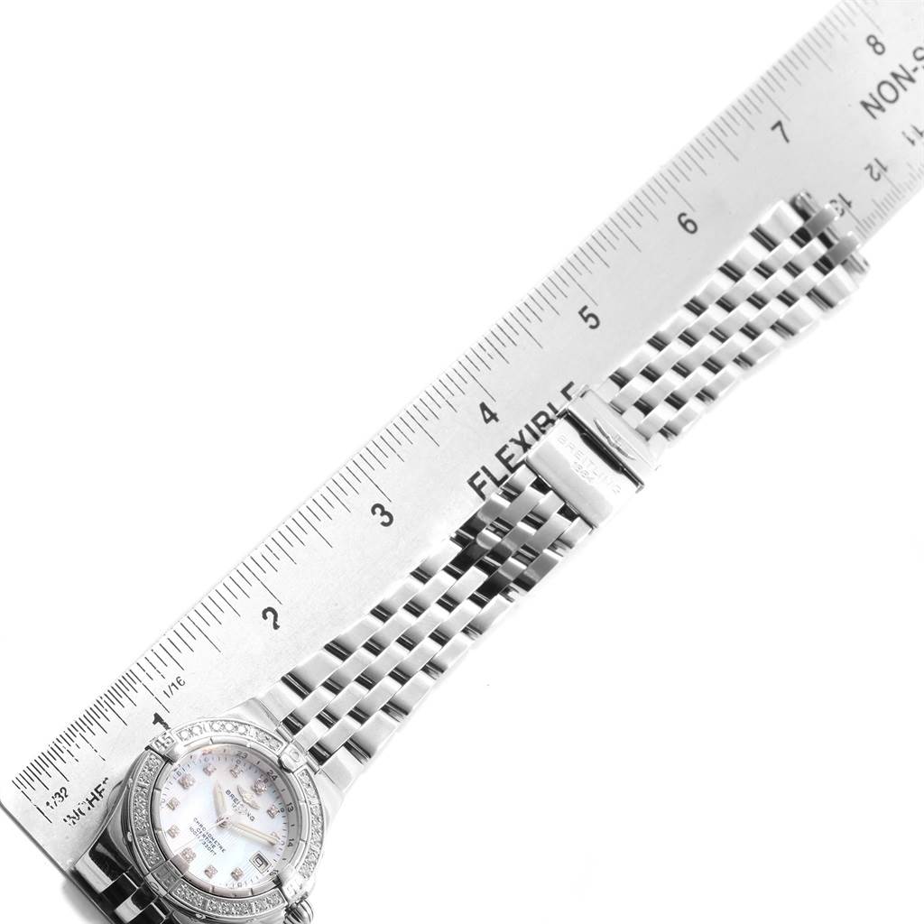 The image shows a Breitling A71340 Women's Stainless Steel Mother of Pearl Dial A71340 Women's Stainless Steel Mother of Pearl Dial Starliner Mother of Pearl Diamond Ladies Watch A71340 model laid next to a ruler, displaying the watch face and part of the bracelet.
