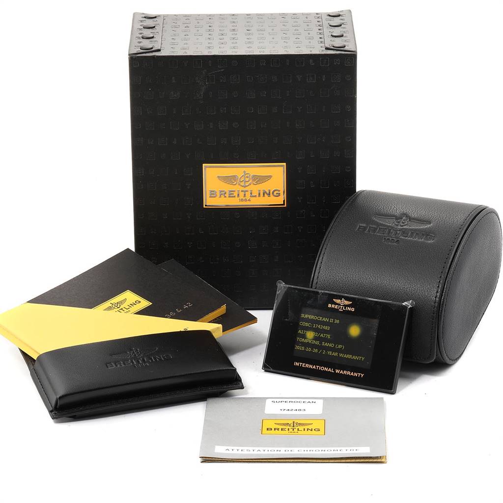 The image shows the Breitling A17312 Women's Stainless Steel White Dial A17312 Women's Stainless Steel White Dial Superocean II 36 Hurricane White Ladies Watch A17312 box, papers, warranty card, and a leather pouch.