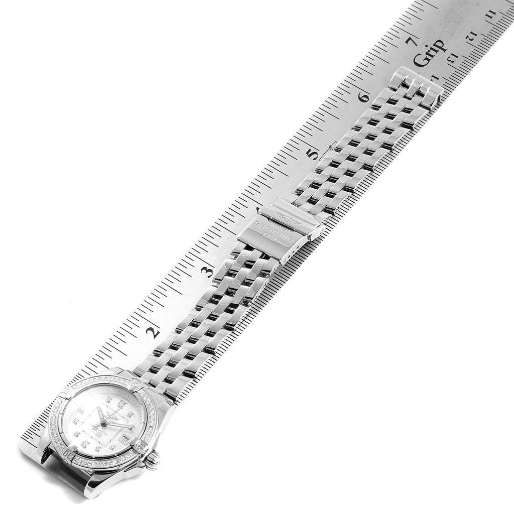 The image shows the Breitling A71356 Women
s Stainless Steel Mother of Pearl Dial A71356 Women
s Stainless Steel Mother of Pearl Dial Cockpit Mother of Pearl Diamond Ladies Watch A71356 model from a top-down angle, emphasizing the bracelet and clasp measured by a ruler.