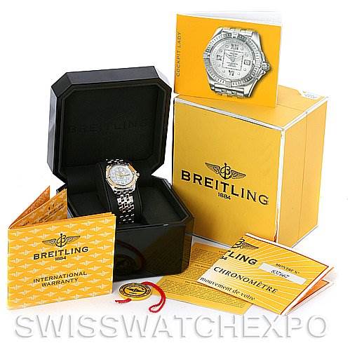 The image shows a Breitling D7135612 Women
s Stainless Steel Mother of Pearl Dial D7135612 Women
s Stainless Steel Mother of Pearl Dial Cockpit Ladies Diamond Watch D7135612 with its box, international warranty, chronometer certificate, and tags.