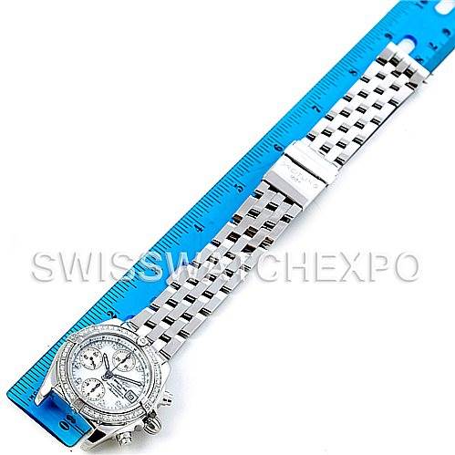 The image shows a Breitling A13358 Women's Stainless Steel Mother of Pearl Dial A13358 Women's Stainless Steel Mother of Pearl Dial Ladies Windrider Cockpit MOP Diamond Watch A13358 laid flat next to a blue measuring ruler.