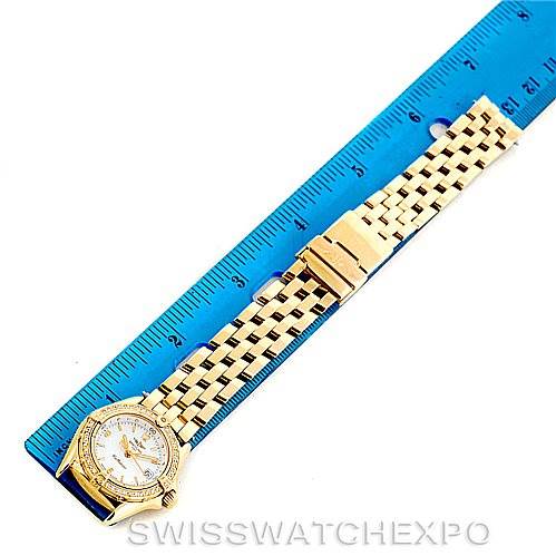 The image shows the full length of the Breitling K52045 Women's Yellow Gold Mother of Pearl Dial K52045 Women's Yellow Gold Mother of Pearl Dial Callistino Ladies 18K Yellow Gold Diamond Watch K52045 model, placed next to a blue ruler.