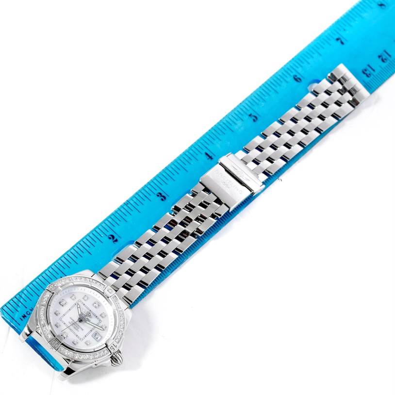 The image shows a top view of a Breitling A71356 Women's Stainless Steel Mother of Pearl Dial A71356 Women's Stainless Steel Mother of Pearl Dial Windrider Cockpit Ladies MOP Diamond Watch A71356 model with a blue ruler for scale.