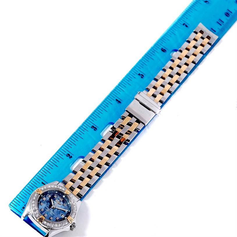 The Breitling A72345 Women's Stainless Steel Mother of Pearl Dial A72345 Women's Stainless Steel Mother of Pearl Dial Callisto Ladies Mother of Pearl Diamond Watch A72345 is shown with a view of its full strap and face alongside a ruler.