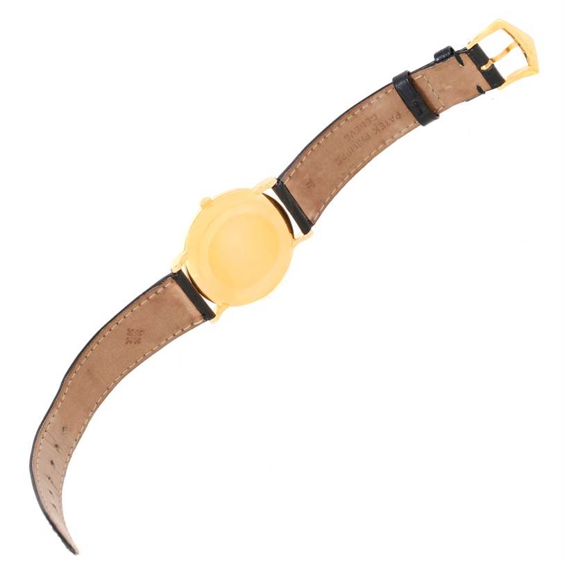 The image shows the back and strap of a Patek Philippe Calatrava 5022 Men's Yellow Gold Champagne Dial 5022 Men's Yellow Gold Champagne Dial watch, highlighting its leather band and gold buckle.