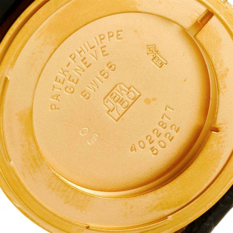 The image shows the case back of a Patek Philippe Calatrava 5022 Men's Yellow Gold Champagne Dial 5022 Men's Yellow Gold Champagne Dial watch, displaying its inscriptions and hallmark details.
