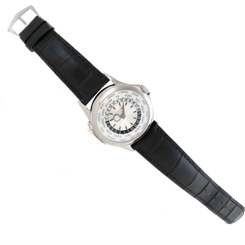 The Patek Philippe Complications 3802R Men's White Gold Silver Dial 3802R Men's White Gold Silver Dial watch is shown from a top-down angle, displaying its face and black leather strap.