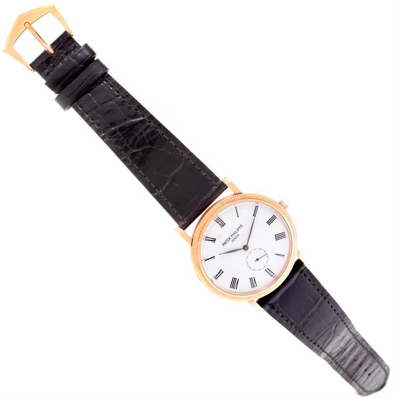 This image shows a top view of a Patek Philippe Calatrava 5119R Men's Rose Gold White Dial 5119R Men's Rose Gold White Dial watch, highlighting its face, strap, and buckle.