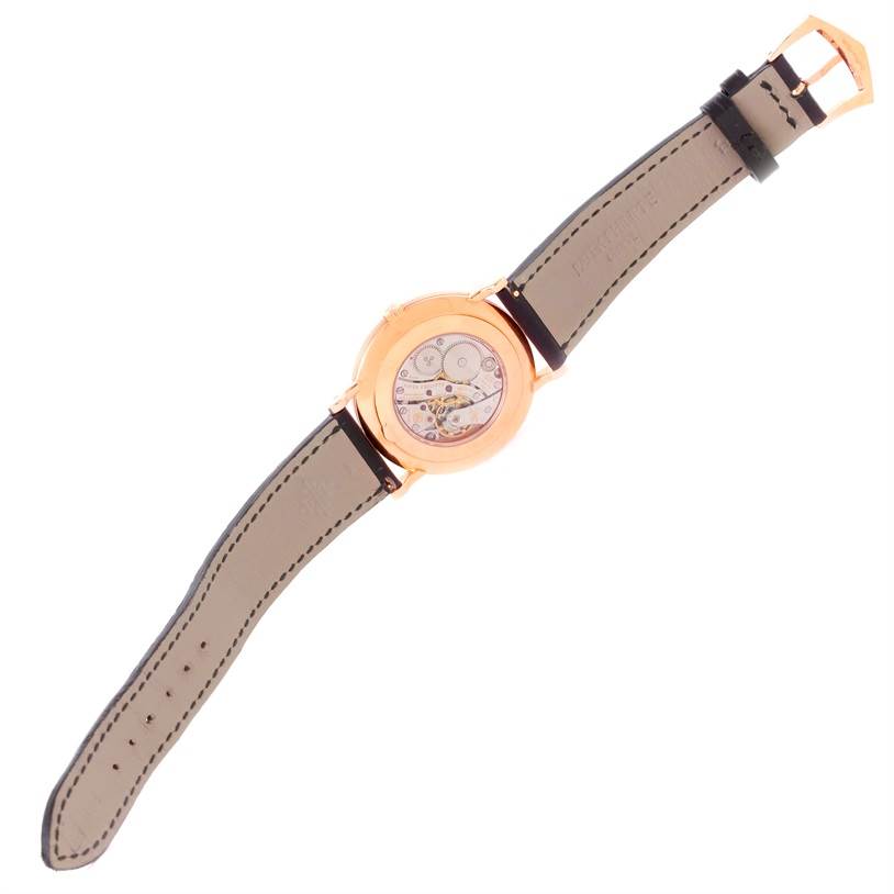 This image shows the back view of a Patek Philippe Calatrava 5119R Men's Rose Gold White Dial 5119R Men's Rose Gold White Dial watch, highlighting the movement and the leather strap.