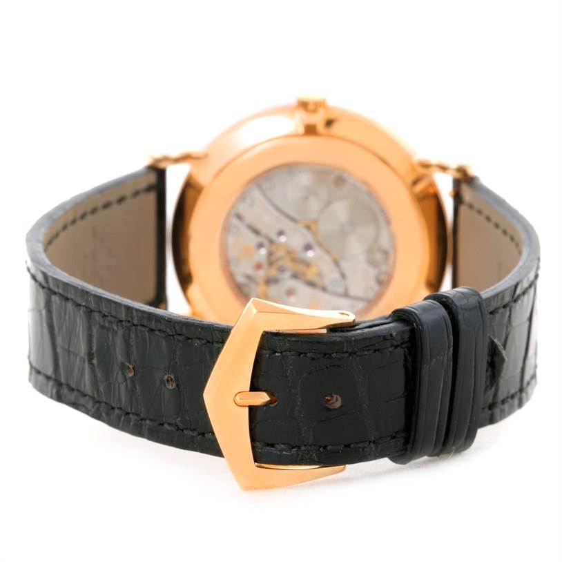 The image shows the rear view of a Patek Philippe Calatrava 5119R Men's Rose Gold White Dial 5119R Men's Rose Gold White Dial watch focusing on its black leather strap and gold buckle.