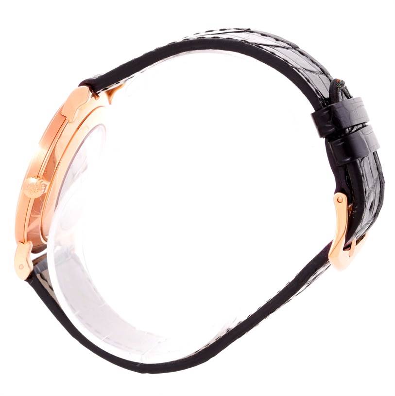 This image shows a side view of a Patek Philippe Calatrava 5119R Men's Rose Gold White Dial 5119R Men's Rose Gold White Dial watch, highlighting the gold case, crown, and black leather strap.