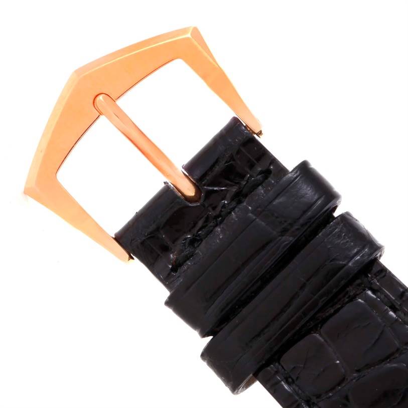 The image shows a close-up of the buckle and strap of a Calatrava model by Patek Philippe.