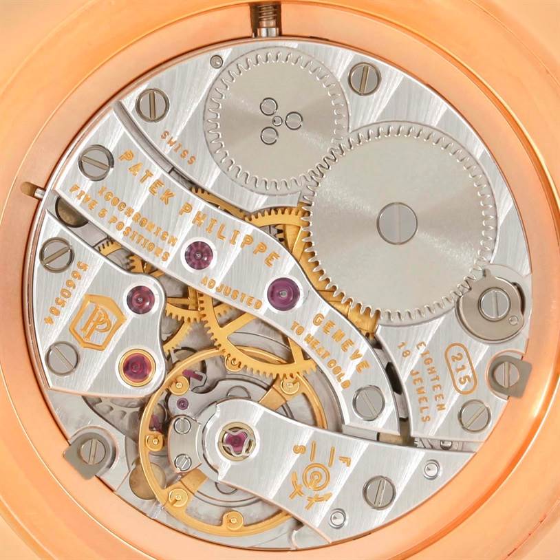 This close-up image shows the intricate movement mechanism of a Patek Philippe Calatrava 5119R Men's Rose Gold White Dial 5119R Men's Rose Gold White Dial watch.