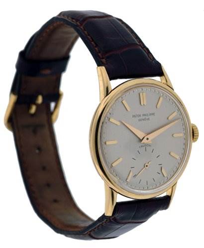 This image shows a side-angle view of the Vintage Patek Philippe watch, featuring its face, gold case, and brown leather strap.